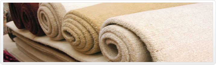 A close up of rolled up carpets on top of a rug.